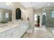 Spacious bathroom with double vanity, white cabinetry, separate shower, and access to walk-in closet at 5301 Meadowcroft Way, Fort Mill, SC 29708