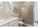 Bright bathroom features a glass enclosed shower, vanity with sink, and modern fixtures at 5301 Meadowcroft Way, Fort Mill, SC 29708