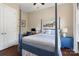 Comfortable bedroom with a four-poster bed, blue accents, and a view of the outdoors at 5301 Meadowcroft Way, Fort Mill, SC 29708