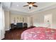 Primary bedroom featuring hardwood floors, tray ceiling, and ensuite bath at 5301 Meadowcroft Way, Fort Mill, SC 29708