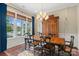 Sunlit dining area showcasing a wooden table and chairs with large windows and a view to the outside at 5301 Meadowcroft Way, Fort Mill, SC 29708