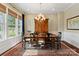 Formal dining room with an elegant chandelier, large windows, and rich wood floors at 5301 Meadowcroft Way, Fort Mill, SC 29708