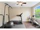 Exercise room with wood floors, ceiling fan, and workout equipment at 5301 Meadowcroft Way, Fort Mill, SC 29708
