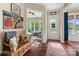 Inviting foyer with hardwood floors, a wooden bench, and a view into the naturally lit sunroom at 5301 Meadowcroft Way, Fort Mill, SC 29708