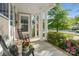 Inviting front porch with rocking chairs, decorative flower pots, and views of the street at 5301 Meadowcroft Way, Fort Mill, SC 29708