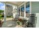 Inviting front porch with rocking chairs, decorative flower pots, and views of the street at 5301 Meadowcroft Way, Fort Mill, SC 29708