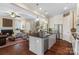 Spacious kitchen island opens to a cozy living room with a fireplace and comfortable seating at 5301 Meadowcroft Way, Fort Mill, SC 29708