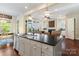 Kitchen island with sink overlooking an eat-in kitchen and cozy fireplace living room at 5301 Meadowcroft Way, Fort Mill, SC 29708