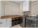 Well-organized laundry room with butcher block countertop, cabinetry, and modern washer and dryer units at 5301 Meadowcroft Way, Fort Mill, SC 29708