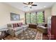 Cozy living room with a comfortable sofa, armchair, patterned rug, and large windows at 5301 Meadowcroft Way, Fort Mill, SC 29708