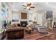 Inviting living room featuring a fireplace, ceiling fan, hardwood floors, and stylish furniture at 5301 Meadowcroft Way, Fort Mill, SC 29708