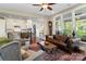 Open concept living area with hardwood floors, large windows, and a seamless flow to the kitchen at 5301 Meadowcroft Way, Fort Mill, SC 29708