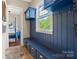 Well-organized mudroom with blue cabinetry, bench seating, and convenient storage hooks at 5301 Meadowcroft Way, Fort Mill, SC 29708