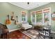 Bright sunroom with ample natural light, a comfortable seating area, and hardwood floors at 5301 Meadowcroft Way, Fort Mill, SC 29708