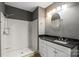 Bright bathroom featuring a shower, vanity with a granite countertop, and a round mirror at 543 Hampton St, Rock Hill, SC 29730