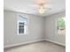 Bright bedroom featuring two windows, neutral walls, and carpeted floors, providing a serene living space at 543 Hampton St, Rock Hill, SC 29730