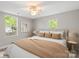 Bright bedroom with large windows, a ceiling fan, neutral colors, and plush bedding, perfect for relaxation at 543 Hampton St, Rock Hill, SC 29730