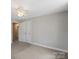 Well-lit bedroom features a double door and a window, complementing its spacious carpeted interior for comfortable living at 543 Hampton St, Rock Hill, SC 29730