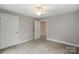 Spacious bedroom with plush carpeting and ample natural light, complemented by a classic white door at 543 Hampton St, Rock Hill, SC 29730