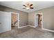 Versatile bedroom with neutral walls, plush carpet, and access to stairs and bathroom, offering flexibility at 543 Hampton St, Rock Hill, SC 29730