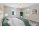 Inviting bedroom with ample natural light from two windows, enhancing the comfort of the soft bedding and pillows at 543 Hampton St, Rock Hill, SC 29730