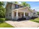 Charming two-story home with a inviting front porch, complemented by a well-maintained lawn and concrete driveway at 543 Hampton St, Rock Hill, SC 29730