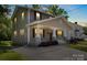 Charming two-story home with a inviting front porch, complemented by a well-maintained lawn and concrete driveway at 543 Hampton St, Rock Hill, SC 29730