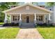 Inviting home exterior showcases a covered front porch with classic columns, landscaped bushes, and a well-manicured lawn at 543 Hampton St, Rock Hill, SC 29730