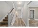 Bright hallway with wood floors, carpeted stairs, and neutral paint, creates a welcoming transition between spaces at 543 Hampton St, Rock Hill, SC 29730