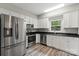 Well-lit kitchen with stainless steel appliances, white cabinets, and a granite countertop at 543 Hampton St, Rock Hill, SC 29730