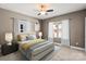 Cozy bedroom with ceiling fan, natural light, neutral walls, plush carpet, and white curtains at 543 Hampton St, Rock Hill, SC 29730