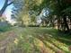 A spacious, tree-filled backyard offers ample space for outdoor enjoyment at 6000 S Main St, Salisbury, NC 28147