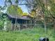 A fenced-in backyard overgrown with weeds provides a secure but unkempt outdoor space at 6000 S Main St, Salisbury, NC 28147
