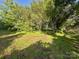 A sprawling green space surrounds by mature trees offers a tranquil and private backyard setting at 6000 S Main St, Salisbury, NC 28147