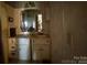 View of a bathroom with a sink, vanity and peeling wall paper at 6000 S Main St, Salisbury, NC 28147