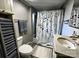 Cozy bathroom featuring a vanity and shower with black-and-white pattern, complemented by a convenient toilet and gray towels at 6000 S Main St, Salisbury, NC 28147