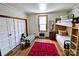 Bright bedroom with bunk beds, a checkered ottoman, wood floors, and a window at 6000 S Main St, Salisbury, NC 28147