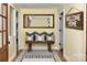 Inviting entryway featuring a wooden bench with cushions, a decorative mirror, and a warm welcome sign at 6000 S Main St, Salisbury, NC 28147