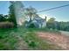 Two-story home with a long sunroom and overgrown lawn on an unkempt property at 6000 S Main St, Salisbury, NC 28147