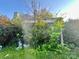 Two-story home with sunroom, surrounded by overgrown bushes and shrubs at 6000 S Main St, Salisbury, NC 28147