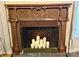 Close-up of a fireplace with candles inside, showcasing detailed woodwork and a decorative design at 6000 S Main St, Salisbury, NC 28147