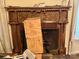 Ornate fireplace with carved wood mantel and a decorative screen at 6000 S Main St, Salisbury, NC 28147