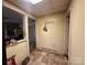The hallway is illuminated by a ceiling light and features neutral-colored walls and a tile floor at 6000 S Main St, Salisbury, NC 28147