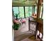 Staged sunroom with plenty of outdoor seating, plants, and many windows overlooking backyard at 6000 S Main St, Salisbury, NC 28147