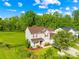 Aerial view of the house featuring manicured lawns, mature trees, and a two-car garage in a serene setting at 6222 Ohaus Ct # 59, Charlotte, NC 28216