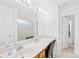 Clean and bright bathroom featuring a large mirror, a well-lit vanity, and a shower-tub combo at 6222 Ohaus Ct # 59, Charlotte, NC 28216