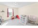 Bright bedroom featuring a ceiling fan, a large window and carpet flooring, creating a cozy and inviting space at 6222 Ohaus Ct # 59, Charlotte, NC 28216