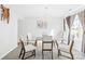 Well-lit dining room with a modern glass table, chandelier, and comfortable seating for a delightful dining experience at 6222 Ohaus Ct # 59, Charlotte, NC 28216