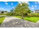Long concrete driveway leading to the house with a well-maintained lawn and blue skies at 6222 Ohaus Ct # 59, Charlotte, NC 28216