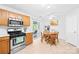Bright kitchen with stainless steel appliances and an eat-in area with a ceiling fan and sliding glass doors at 6222 Ohaus Ct # 59, Charlotte, NC 28216